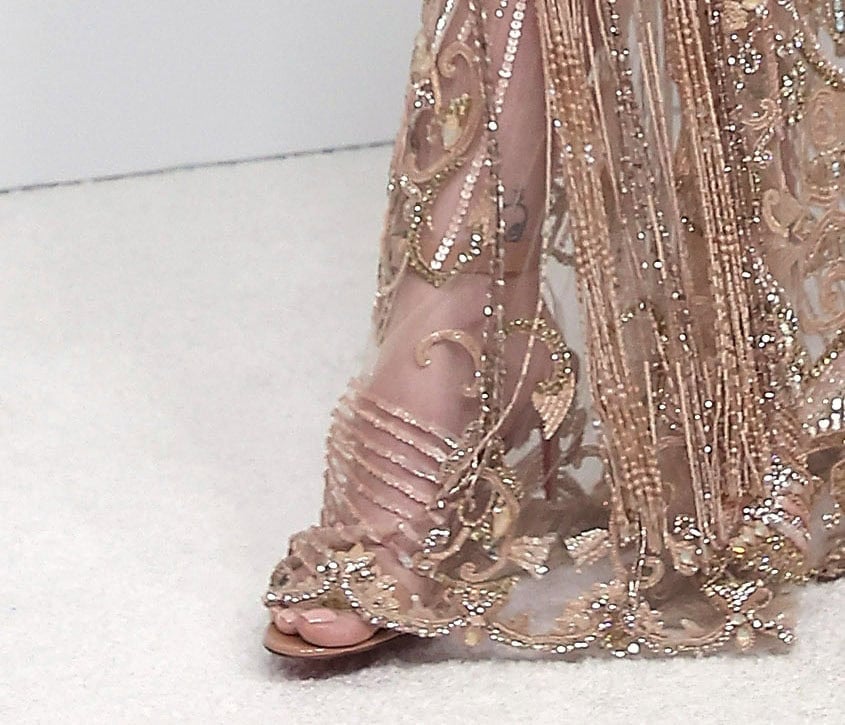 Paris Jackson goes nude in Christian Louboutin Jonatina sandals with two plexi straps at the back, creating the illusion of a floating ankle strap